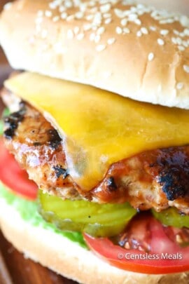 Turkey burger with melted cheese pickles tomatoes and lettuce