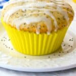 Glazed Lemon Poppy Seed Muffins On A White Plate