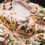 Creamy garlic chicken marsala in a pan with a spoon