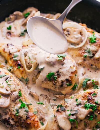 Creamy garlic chicken marsala in a pan with a spoon