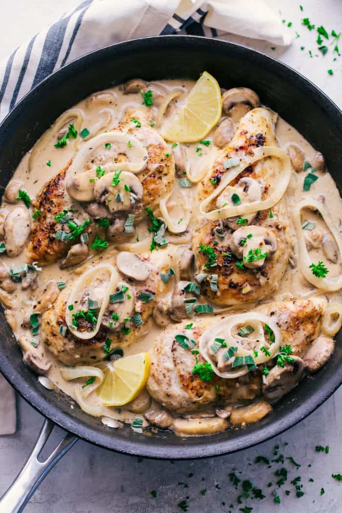 Creamy garlic chicken marsala in a pan with parsley and Sage