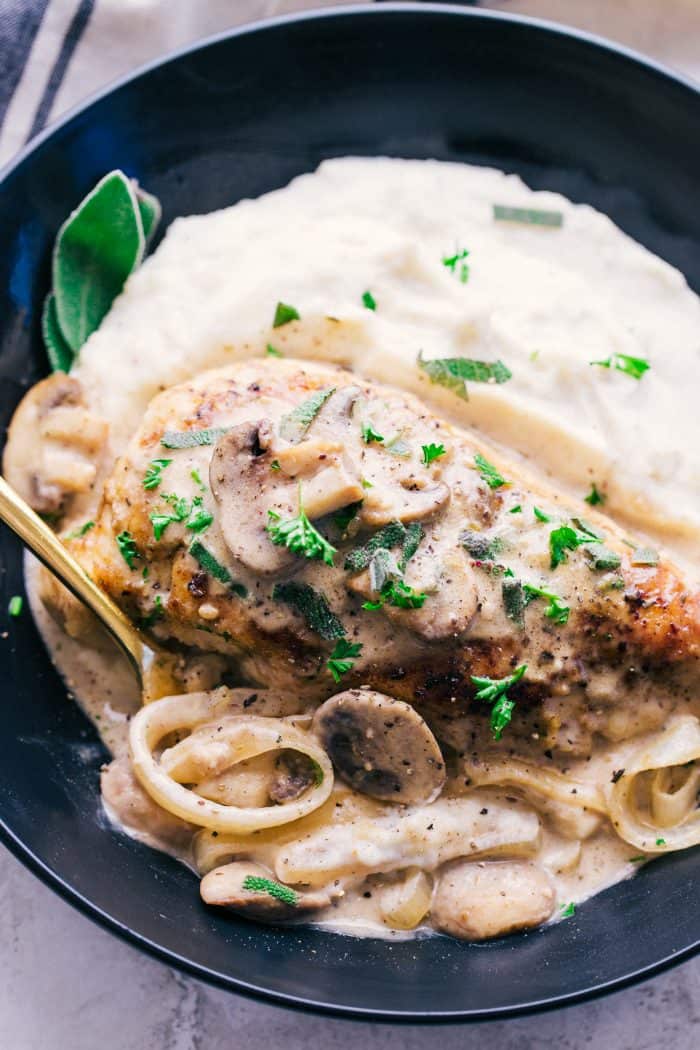 Creamy garlic chicken marsala on a plate with noodles and parsley