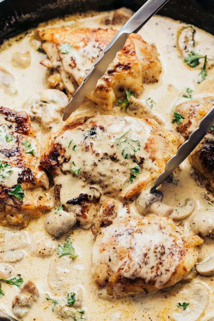 Creamy Parmesan Dijon Chicken Skillet with tongs
