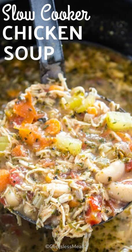 Slow cooker chicken soup in a slow cooker with a ladle and a title