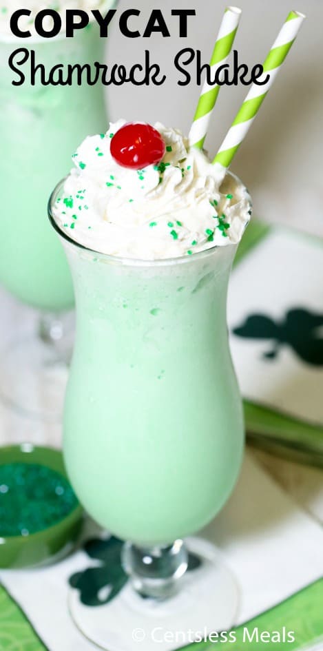 Shamrock Shake in a glass with a cherry and straws with writing