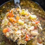 Slow cooker chicken soup with a ladle
