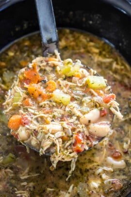Slow cooker chicken soup with a ladle