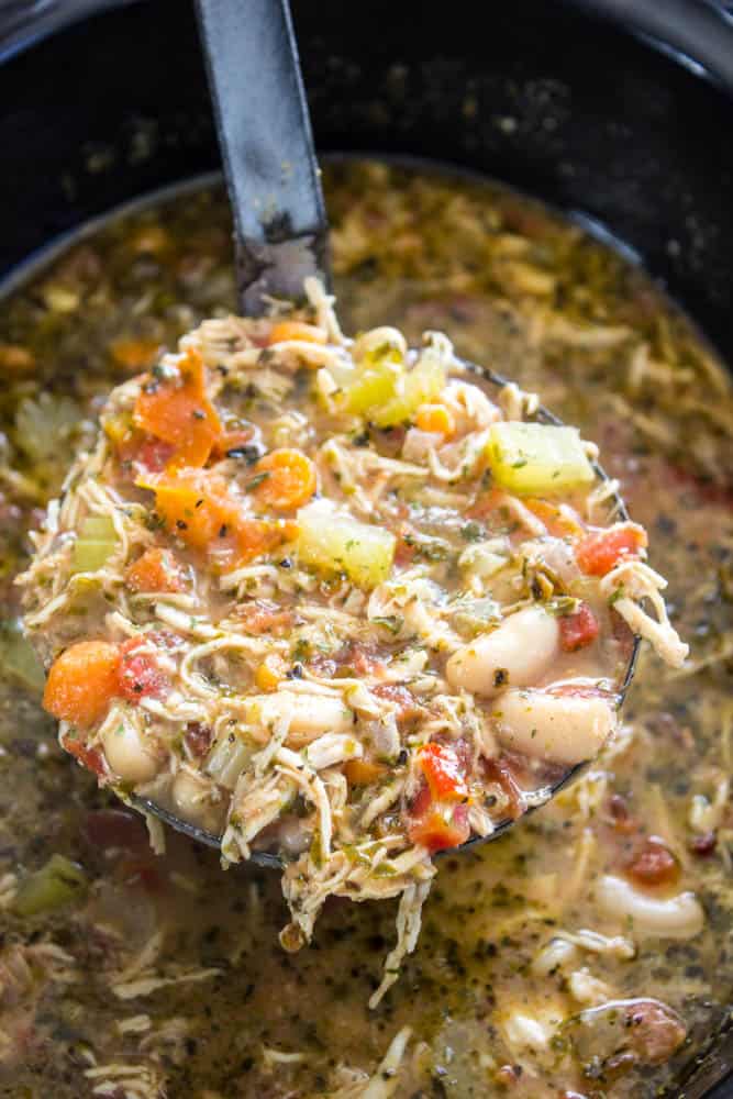 Slow cooker chicken soup with a ladle