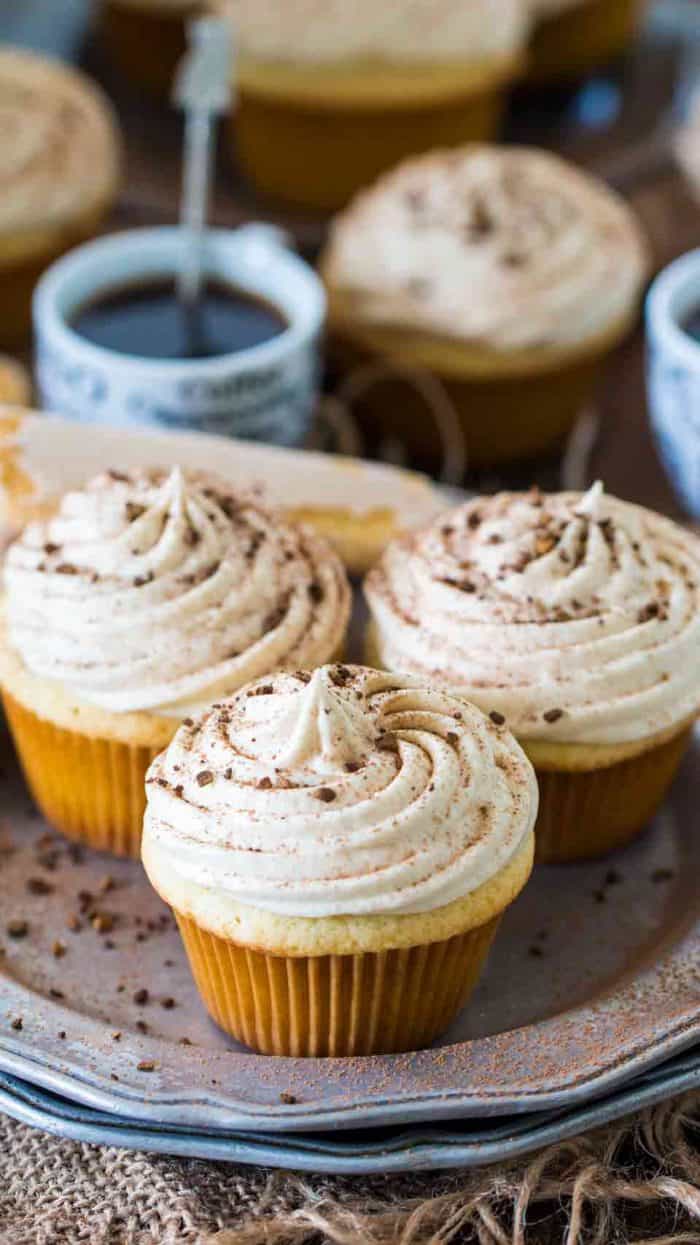 Tiramisu cupcakes on a plate with icing and chocolate