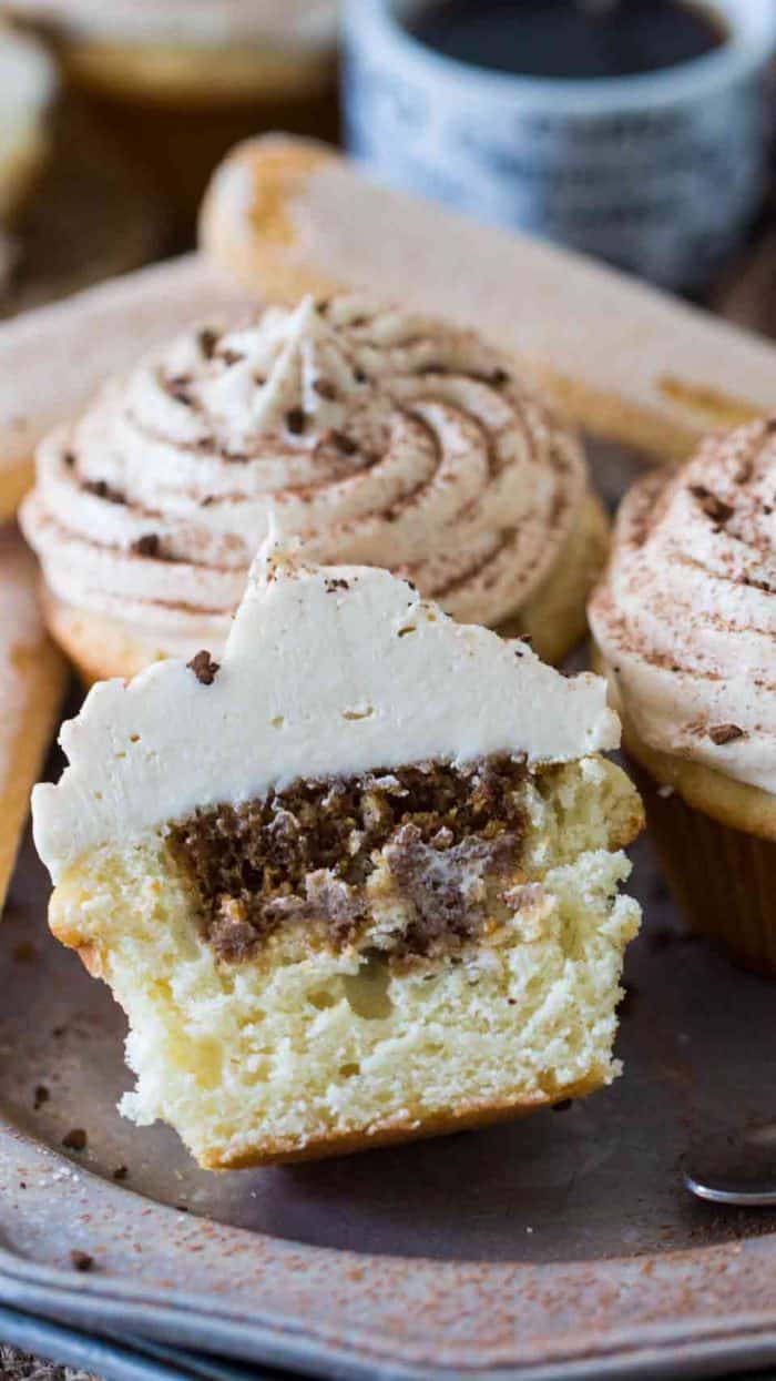 Tiramisu cupcake cut in half on a plate