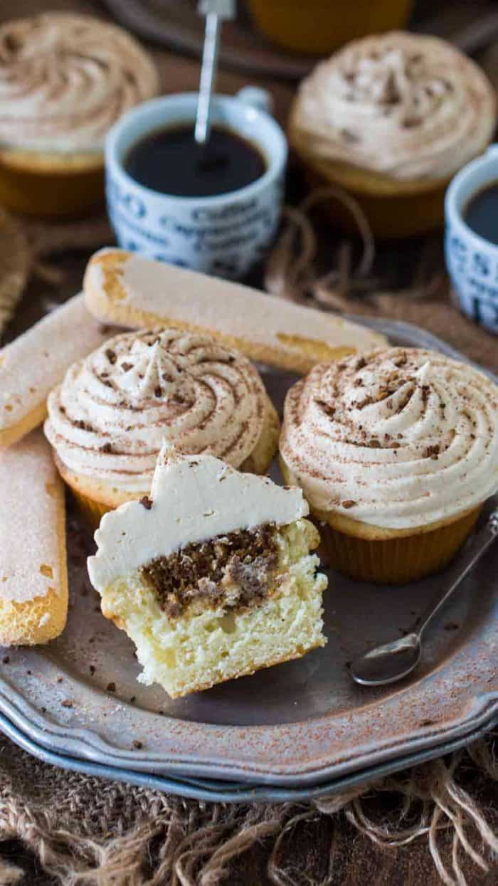 Tiramisu cupcakes on a plate with one cut in half