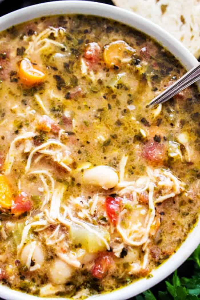 Slow cooker chicken soup in a bowl with a spoon