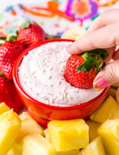 Strawberry fruit dip with a strawberry being dipped in