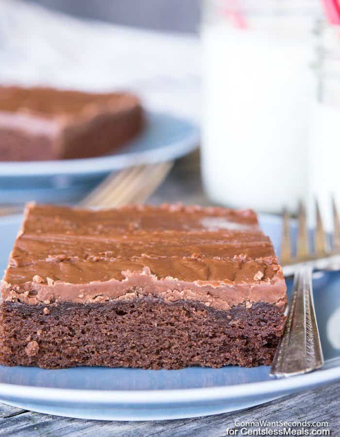 Texas Sheet Cake on a blue plate with a fork