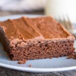 Texas Sheet Cake on a blue plate with a fork on the side