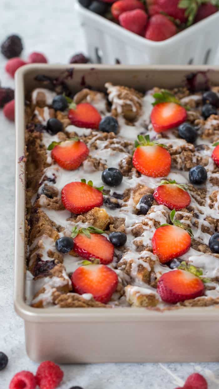 french toast bake in a pan, topped with berries
