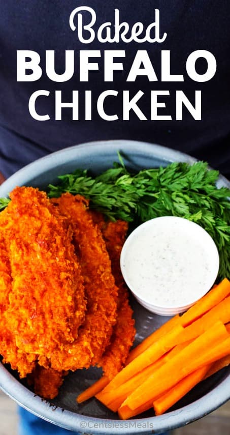 Baked buffalo chicken on a plate with veggies