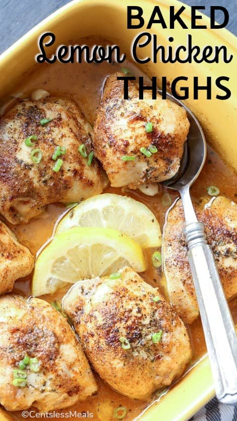 Baked lemon chicken thighs in a yellow casserole dish with green onion and lemon
