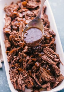 slow cooker roast beef in a dish with sauce on a spoon