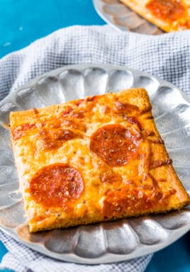 Piece of crescent roll pizza on a metal plate