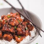 Instant pot honey garlic chicken garnished with green onion and sesame seeds