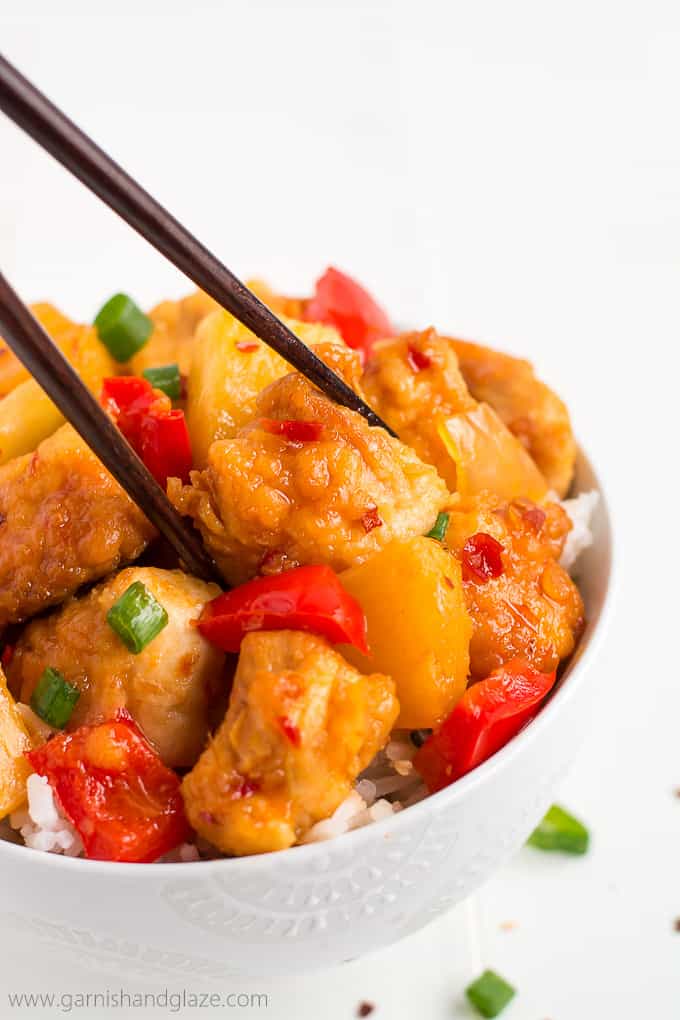 Thai sweet chili chicken in a bowl with rice and chopsticks