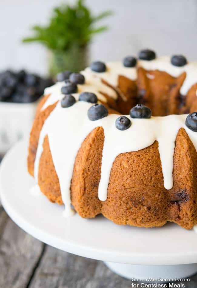 Blueberry coffee cake on a white cake stand