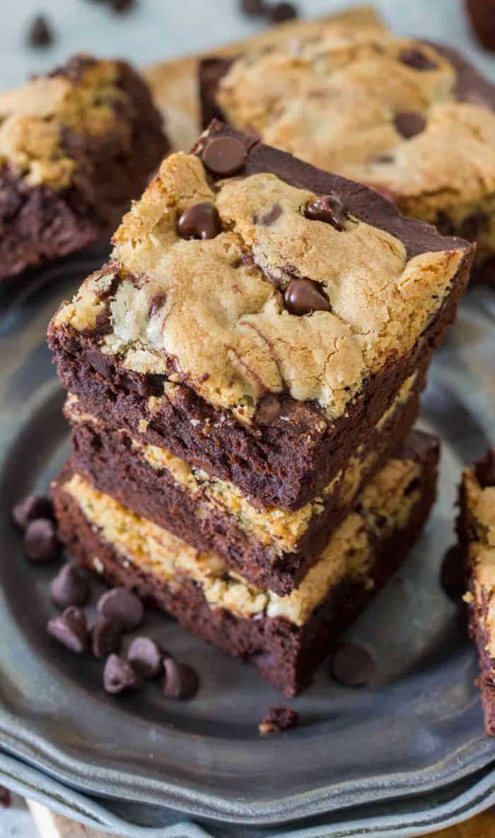 Brookie bars stacked up on a plate with chocolate chips