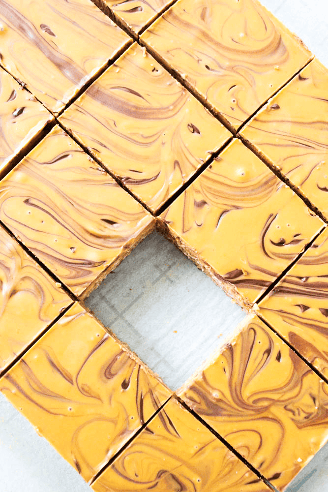 squares of Peanut butter butterscotch bars on parchment paper