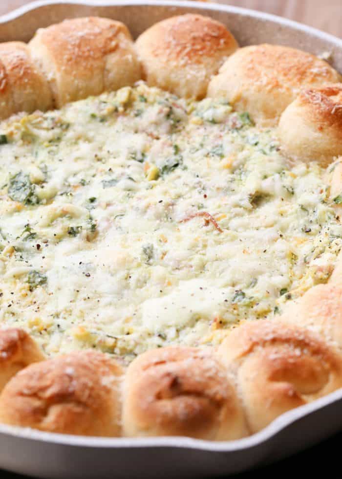 Pull-A-Part crescents with spinach artichoke dip in a skillet