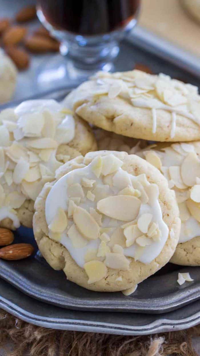 Buttery almond cookies on a plate with slivers of almond as garnish