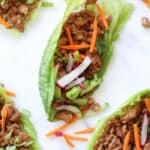 Chicken lettuce wraps with radishes green onions and carrots