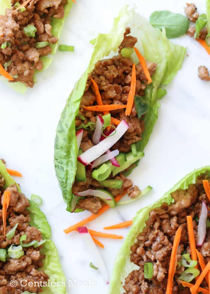 Chicken lettuce wraps with radishes green onions and carrots