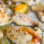 Oven-baked rosemary chicken on parchment paper with rosemary