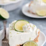Key lime pie on a plate garnished with lime
