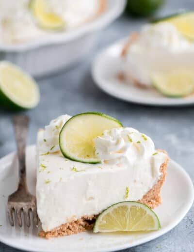 Key lime pie on a plate garnished with lime