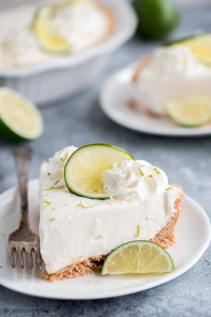 Key lime pie on a plate garnished with lime