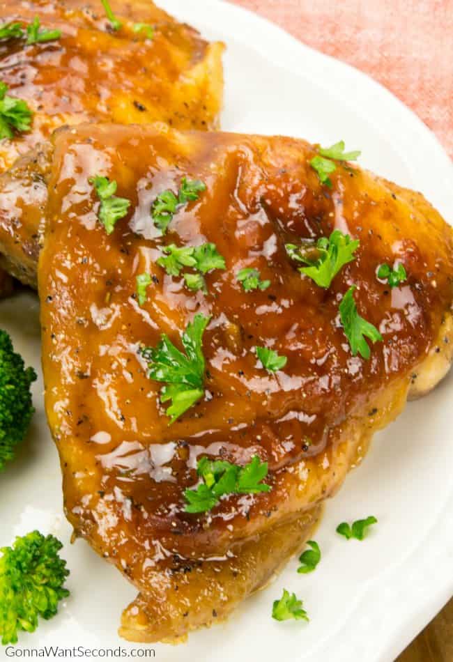 Honey garlic chicken on a plate with parsley