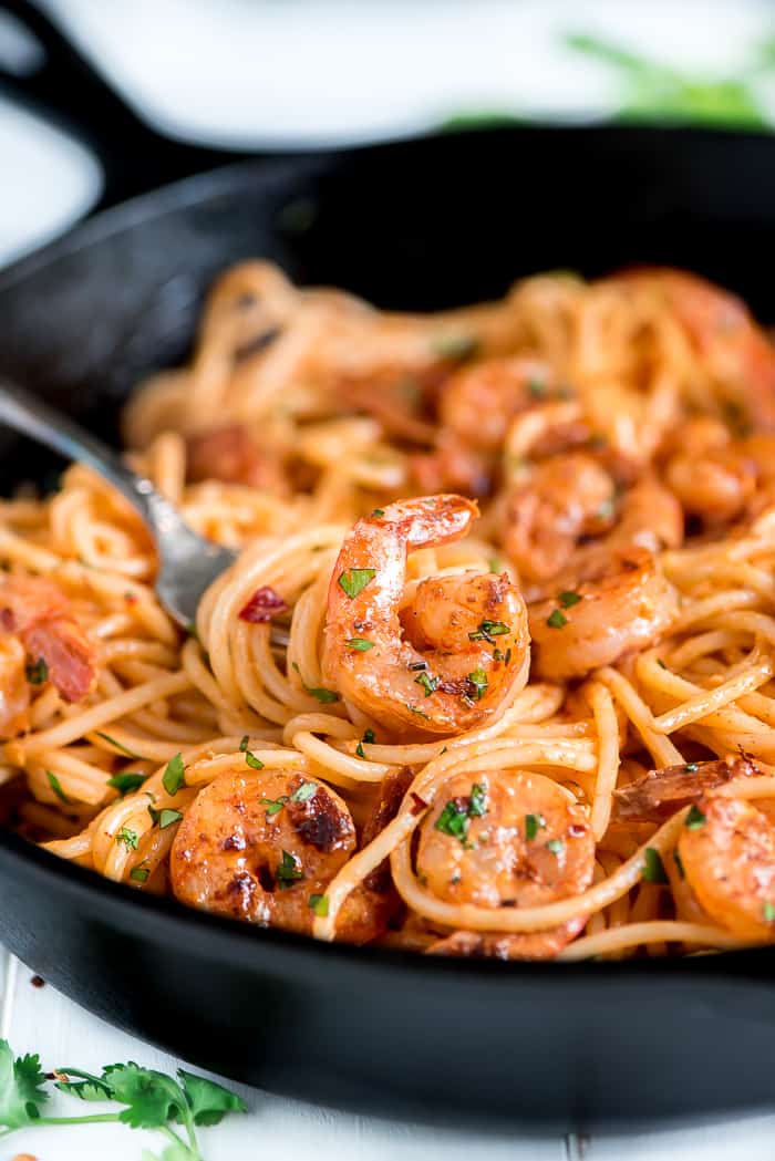 Bang bang shrimp pasta in a pan with a bite on a fork