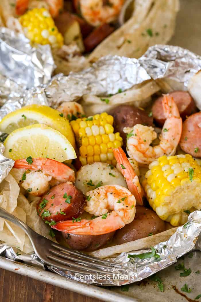 Shrimp boil foil packets with parsley and a fork