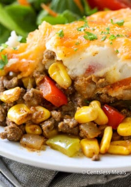 Taco shepherd's pie on a white plate garnished with parsley