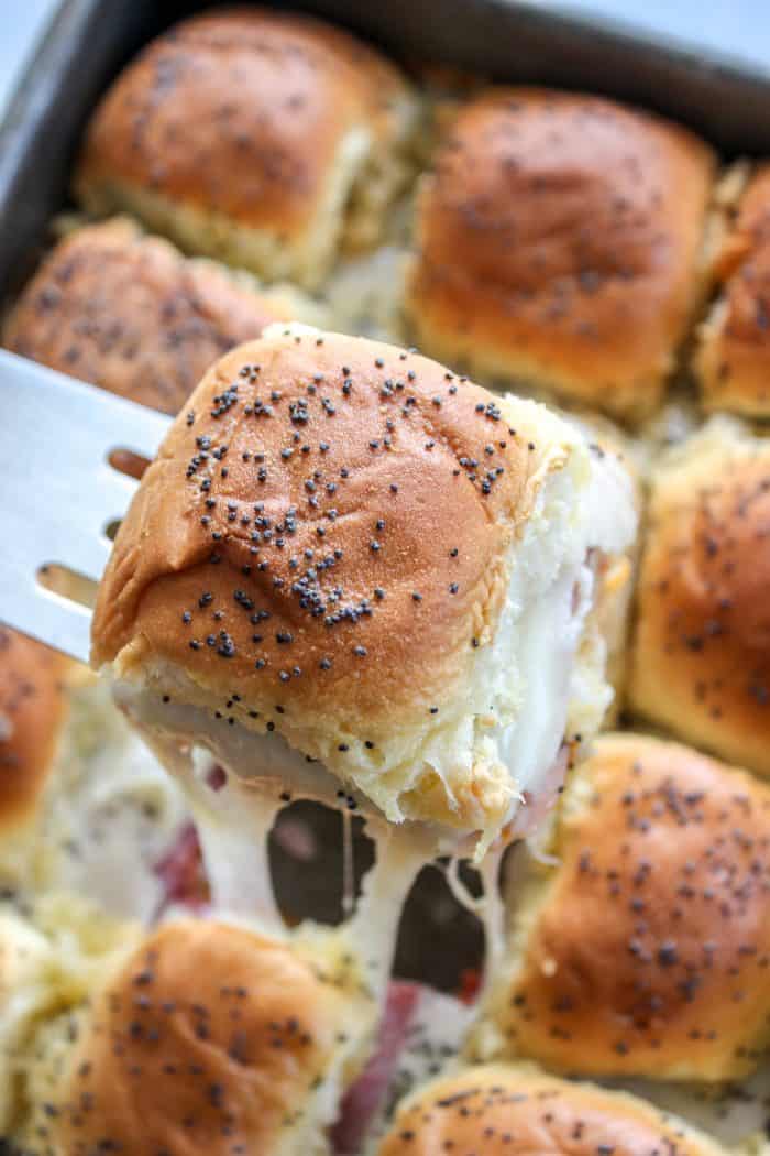 Italian Sliders in a pan with one being pulled out
