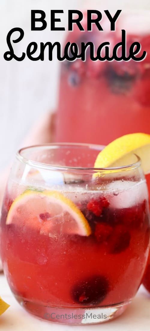 Berry lemonade in a glass with berries and lemon with a title