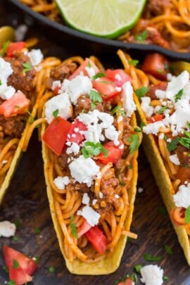 Spaghetti tacos on a wooden board