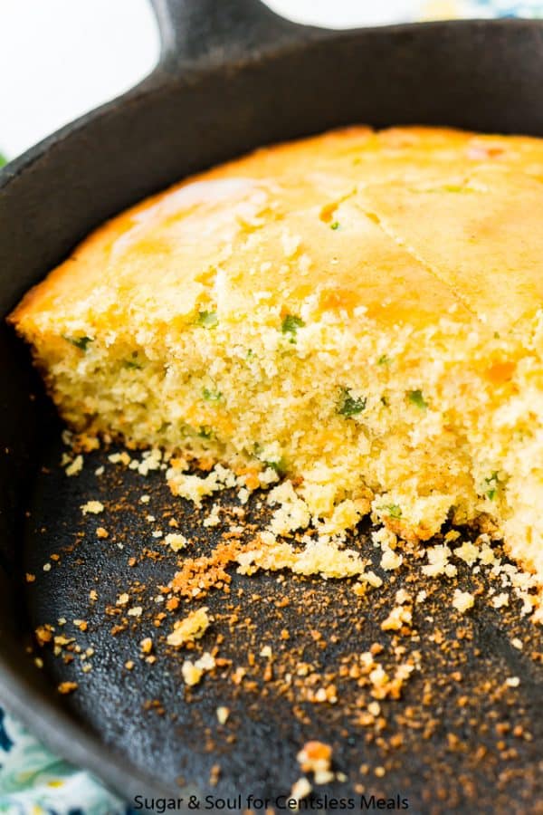 Jalapeno cornbread in a cast iron pan with some slices taken out