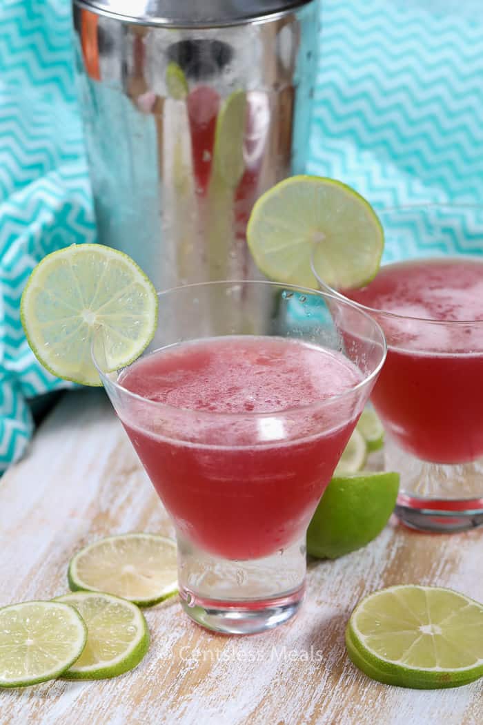 Cosmo cocktails on a wooden board with lime