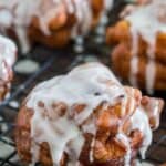 Apple fritters with icing and cinnamon sticks