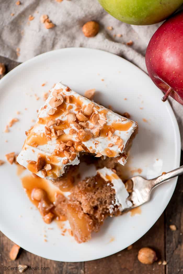 Caramel apple poke cake on a plate with a fork