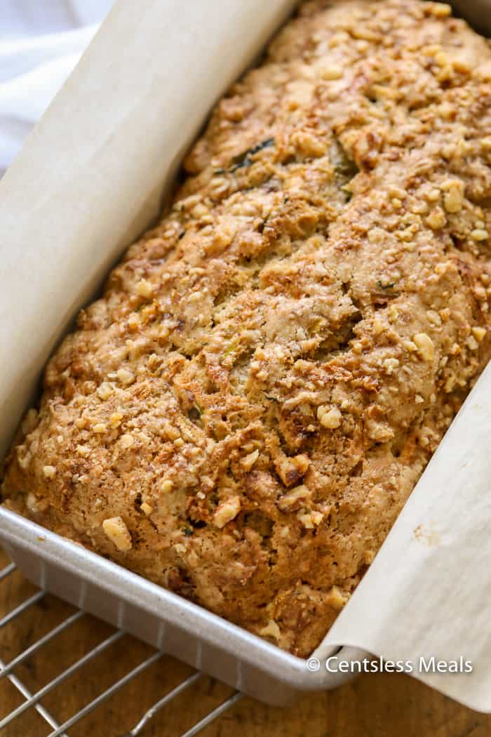 Zucchini bread in a loaf pan with parchment paper