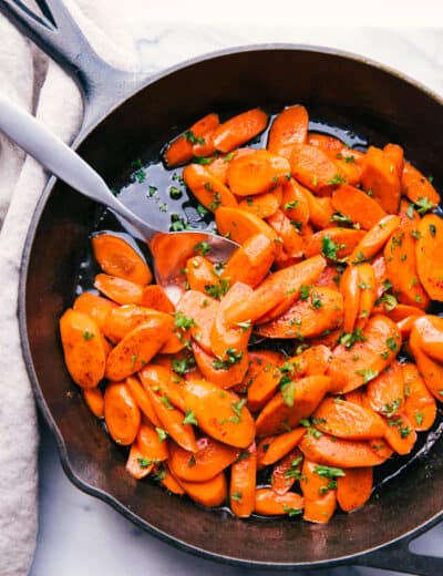 candied carrots served out of a skillet with brown sugar glaze
